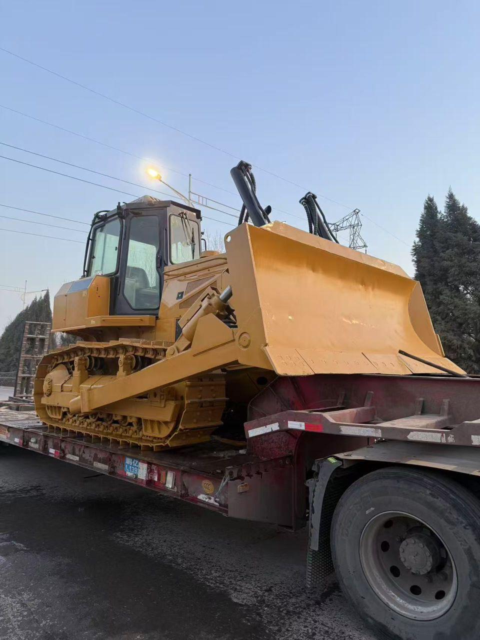 Tracked bulldozer being delivered on a low-loader
